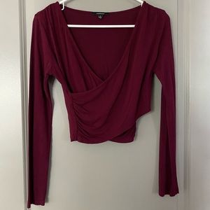 Long sleeve cropped top with surprise neckline.